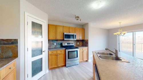 334 Grosbeak Way, Fort Mcmurray, AB - Indoor Photo Showing Kitchen With Stainless Steel Kitchen With Double Sink