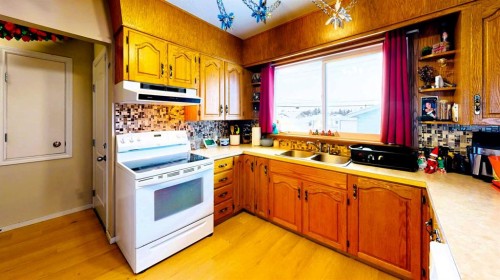 10314-101A Avenue, Lac La Biche, AB - Indoor Photo Showing Kitchen With Double Sink