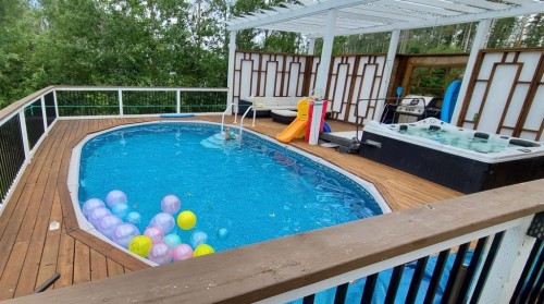 103 Donovan Drive, Anzac, AB - Outdoor With Above Ground Pool With Deck Patio Veranda