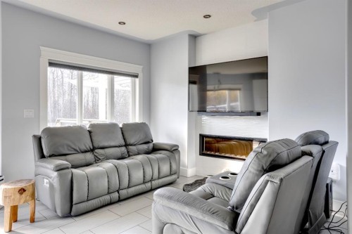 103 Donovan Drive, Anzac, AB - Indoor Photo Showing Living Room With Fireplace