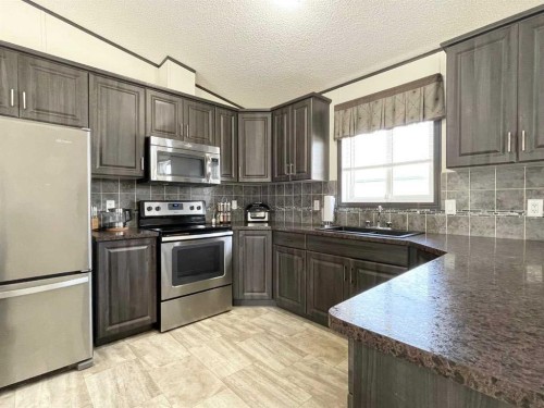 145 Caouette Crest, Fort Mcmurray, AB - Indoor Photo Showing Kitchen With Stainless Steel Kitchen