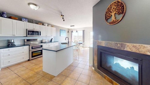 9221 91 Ave, Lac La Biche, AB - Indoor Photo Showing Kitchen With Fireplace