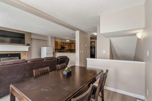 93-313 Millennium Drive, Fort Mcmurray, AB - Indoor Photo Showing Dining Room With Fireplace
