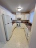 207-9028 Alberta Avenue, Lac La Biche, AB  - Indoor Photo Showing Kitchen With Double Sink 