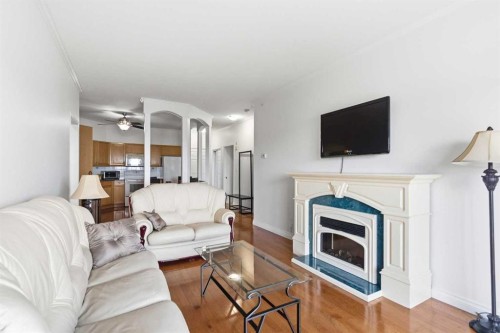 406-253 Gregoire Drive, Fort Mcmurray, AB - Indoor Photo Showing Living Room With Fireplace