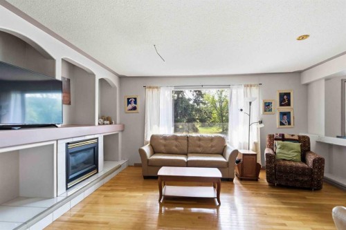25 Crescent Heights, Fort Mcmurray, AB - Indoor Photo Showing Living Room With Fireplace