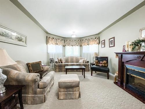 5205 59 Street Close, Stettler, AB - Indoor Photo Showing Living Room With Fireplace