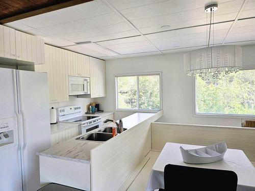 753 Elk Street, Sunbreaker Cove, AB - Indoor Photo Showing Kitchen With Double Sink