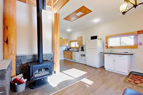 6131 314 Township, Rural Mountain View County, AB - Indoor Photo Showing Kitchen With Fireplace