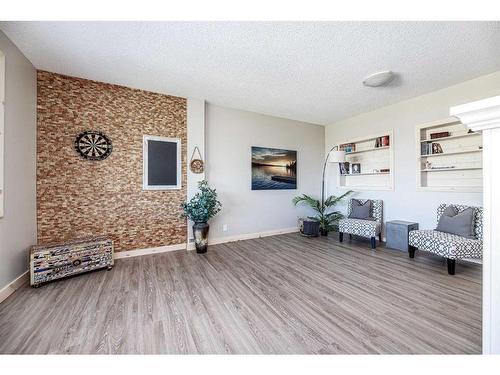 711 Elk Street, Sunbreaker Cove, AB - Indoor Photo Showing Living Room With Fireplace