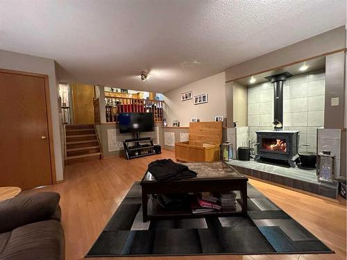 6123 52 Street Close, Ponoka, AB - Indoor Photo Showing Living Room With Fireplace