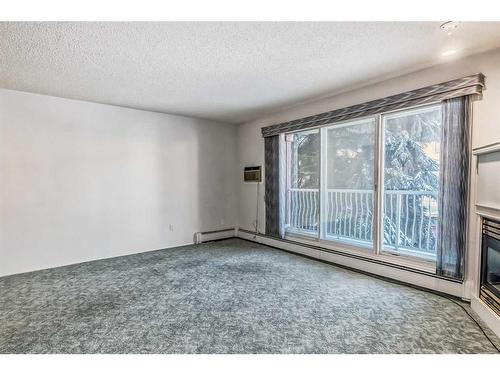 206-5330 47 Avenue, Red Deer, AB - Indoor Photo Showing Other Room With Fireplace
