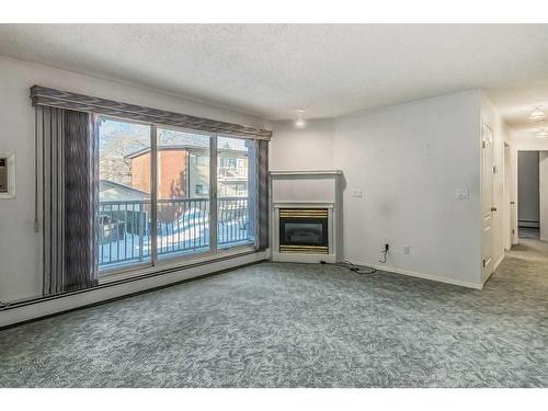 206-5330 47 Avenue, Red Deer, AB - Indoor Photo Showing Living Room With Fireplace
