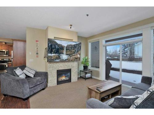 105-4707 50 Street, Sylvan Lake, AB - Indoor Photo Showing Living Room With Fireplace