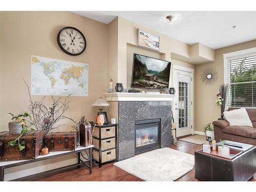 307-4707 50 Street, Sylvan Lake, AB - Indoor Photo Showing Living Room With Fireplace