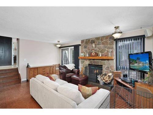 5904 56 Street, Rocky Mountain House, AB - Indoor Photo Showing Living Room With Fireplace