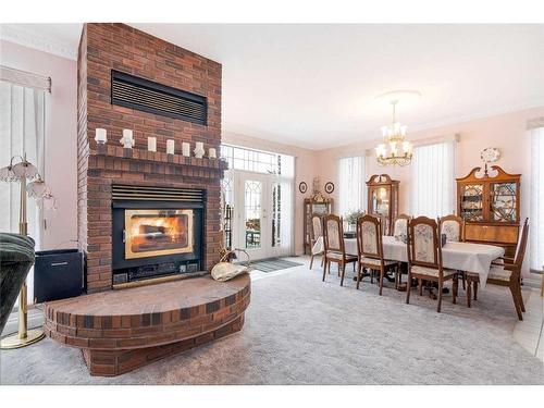 3 Rustic Road, Norglenwold, AB - Indoor With Fireplace