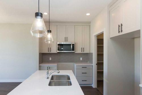172 Emberside Hollow, Cochrane, AB - Indoor Photo Showing Kitchen With Double Sink