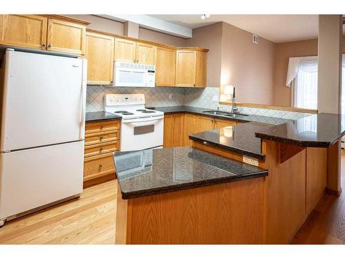 120-5300 48 Street, Red Deer, AB - Indoor Photo Showing Kitchen With Double Sink