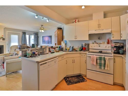 204-5419 49 Avenue, Camrose, AB - Indoor Photo Showing Kitchen With Fireplace With Double Sink