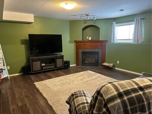 4407 58 Street Close, Rocky Mountain House, AB - Indoor Photo Showing Living Room With Fireplace
