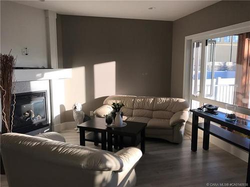 74 Lalor Drive, Red Deer, AB - Indoor Photo Showing Living Room With Fireplace
