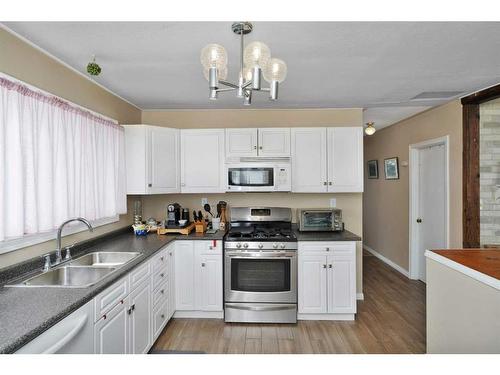 4624 48 Street, Sylvan Lake, AB - Indoor Photo Showing Kitchen With Double Sink