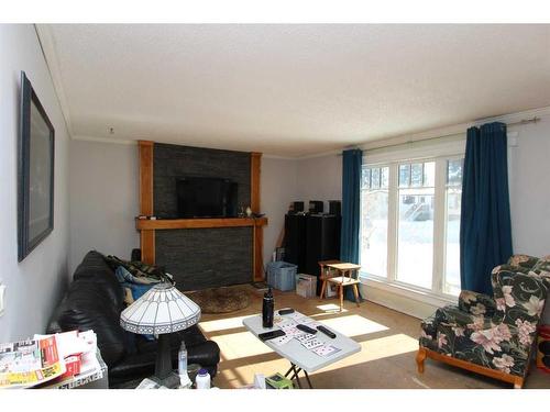 5112 51 Avenue, Caroline, AB - Indoor Photo Showing Living Room With Fireplace