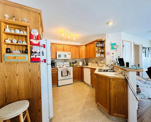 #16 100 Legacy Lane, Rimbey, AB - Indoor Photo Showing Kitchen With Double Sink