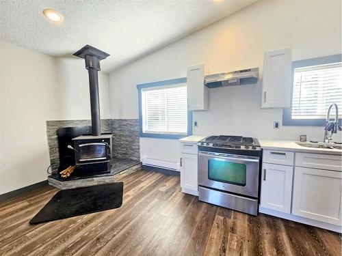 73082 Southshore Drive East, Widewater, AB - Indoor Photo Showing Kitchen With Fireplace