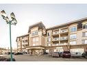 403-4425 Heritage Way, Lacombe, AB  - Outdoor With Balcony With Facade 