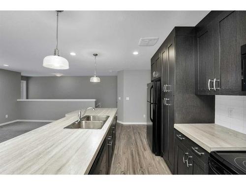 #202-45 Reid Court, Sylvan Lake, AB - Indoor Photo Showing Kitchen With Double Sink