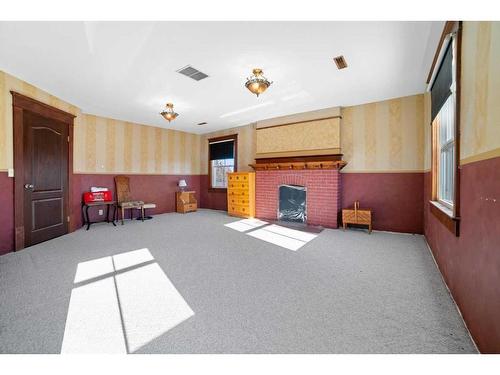 115 Hanson Street, Bawlf, AB - Indoor Photo Showing Other Room With Fireplace
