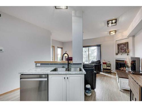 304-5300 48 Street, Red Deer, AB - Indoor Photo Showing Kitchen With Fireplace With Double Sink