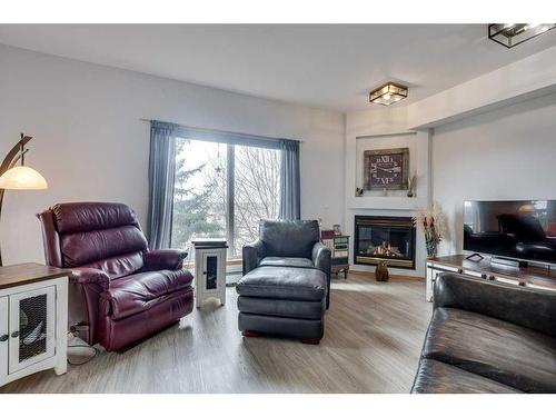 304-5300 48 Street, Red Deer, AB - Indoor Photo Showing Living Room With Fireplace