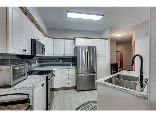304-5300 48 Street, Red Deer, AB - Indoor Photo Showing Kitchen With Double Sink