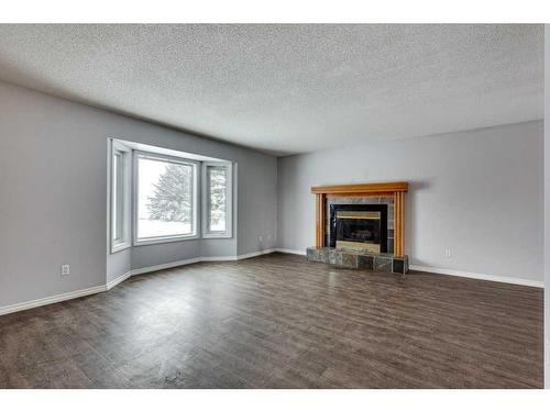 5668 45 Street, Innisfail, AB - Indoor Photo Showing Living Room With Fireplace