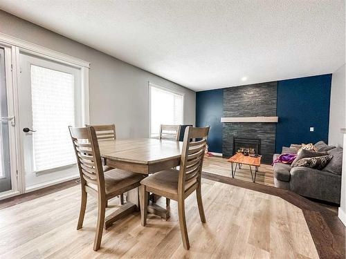 4108 65A Street, Stettler, AB - Indoor Photo Showing Dining Room With Fireplace