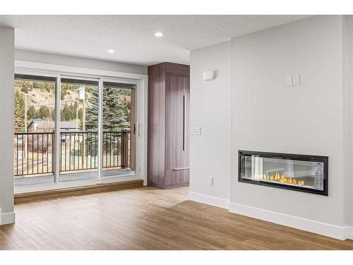 Unit 1-1615 1 Avenue, Canmore, AB - Indoor Photo Showing Living Room With Fireplace