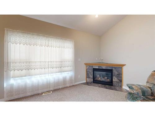 5008 B 49 Street, Stettler, AB - Indoor Photo Showing Living Room With Fireplace