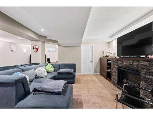 21 Silverstone Mews Nw, Calgary, AB - Indoor Photo Showing Living Room With Fireplace