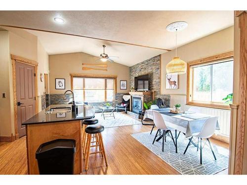 3911 50 Avenue, Sylvan Lake, AB - Indoor Photo Showing Dining Room With Fireplace