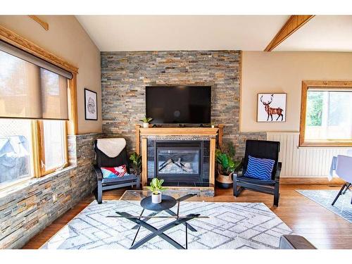 3911 50 Avenue, Sylvan Lake, AB - Indoor Photo Showing Living Room With Fireplace