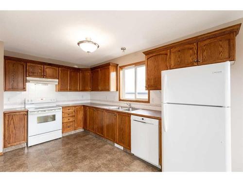 54 Herder Drive, Sylvan Lake, AB - Indoor Photo Showing Kitchen With Double Sink