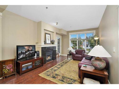 203-4707 50 Street, Sylvan Lake, AB - Indoor Photo Showing Living Room With Fireplace