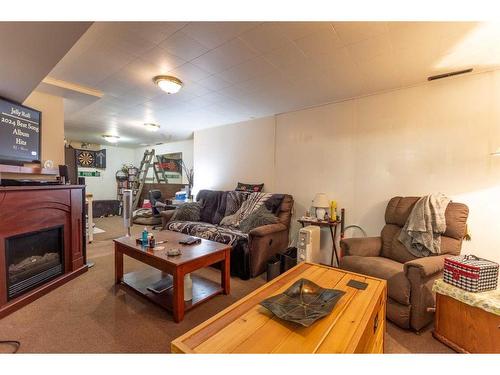 4015 57 Street, Stettler, AB - Indoor Photo Showing Living Room With Fireplace