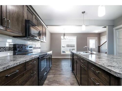 1-21 Crimson Court, Blackfalds, AB - Indoor Photo Showing Kitchen With Double Sink With Upgraded Kitchen