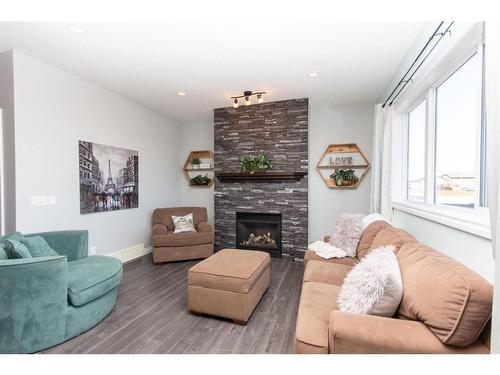 624 Robinson Avenue, Penhold, AB - Indoor Photo Showing Living Room With Fireplace