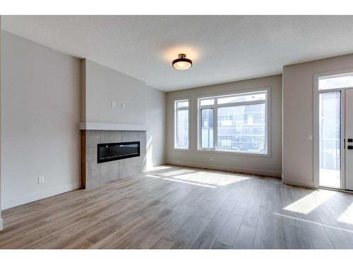 57 Royal Elm Green Nw, Calgary, AB - Indoor Photo Showing Living Room With Fireplace