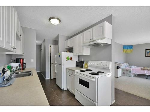 103-4904 54 Street, Red Deer, AB - Indoor Photo Showing Kitchen With Double Sink